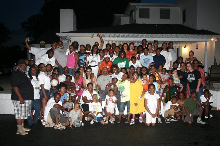 Large family group photo outside at night